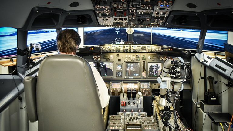 An IT specialist at the John A. Volpe National Transportation Systems Center flies a Boeing 737-800NG simulator with Aurora’s ALIAS technology demonstration system as his co-pilot.