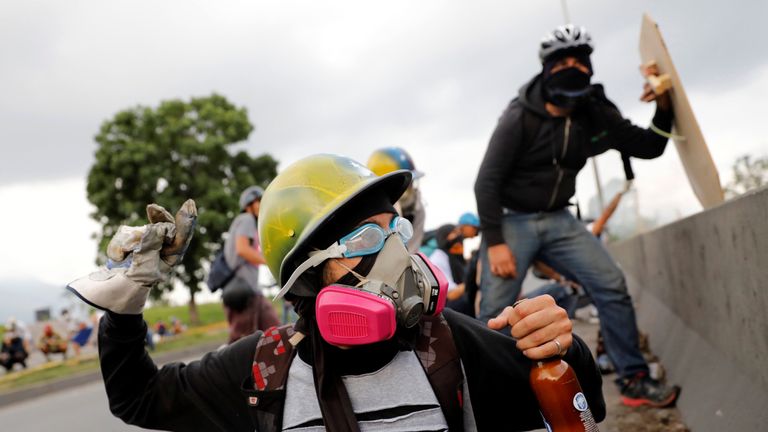 Opposition supporter clash with riot police while rallying against Venezuelan President Nicolas Maduro in Caracas