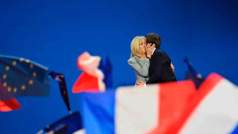 Emmanuel and Brigitte Macron celebrate after he advances to the second round of the election