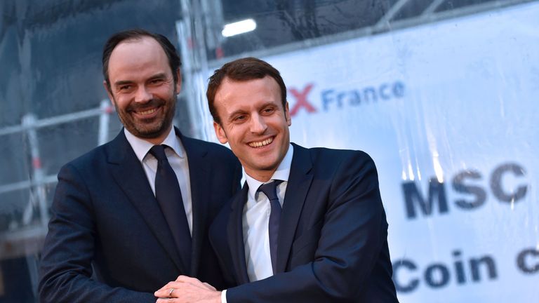 Emmanuel Macron and Edouard Philippe shake hands during a meeting in February 2016
