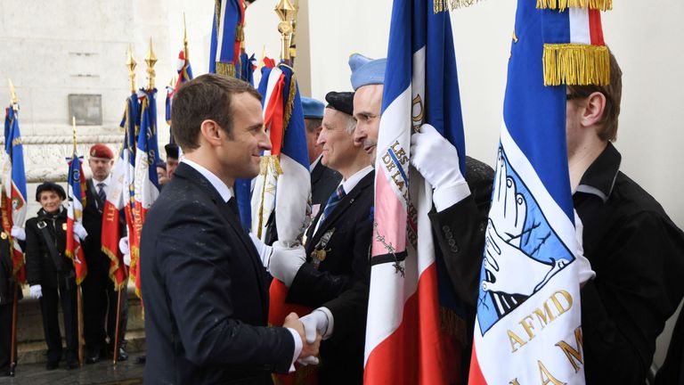 Macron greets veterans after laying a wreath on the unknown Soldier's tomb