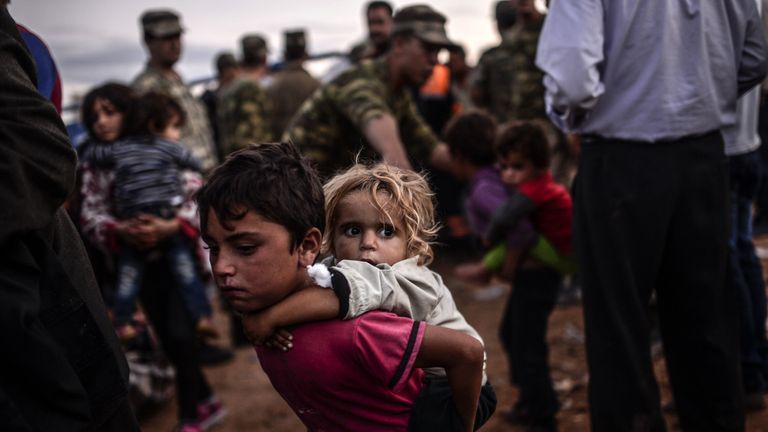 Syrian children displaced by the civil war cross the border to Turkey