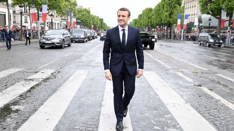 French President Emmanuel Macron walks to the Arc du Triomphe monument