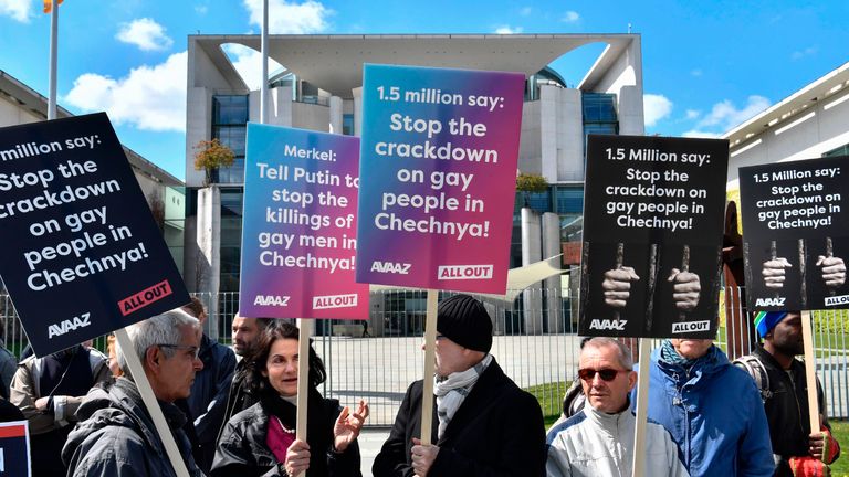 Activists display placards in front of the Chancellery in Berlin on April 30, 2017, during a demonstration calling on Russian President to put an end to the persecution of gay men in Chechnya
