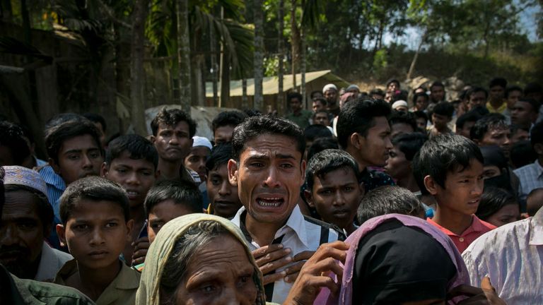 Rohingya refugees gather for aid supplies in Bangladesh in February