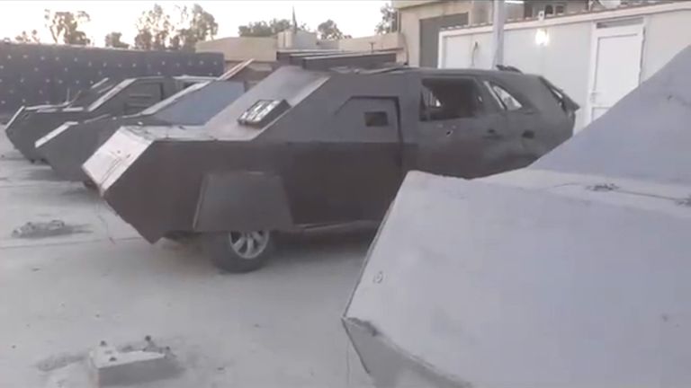 Iraqi police exhibit a number of captured IS vehicles of the kind used in suicide attacks