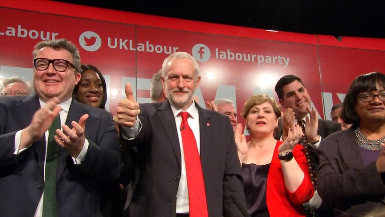 Jeremy Corbyn on stage at campaign launch with his thumbs up.