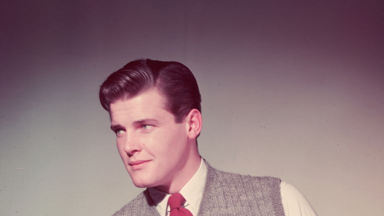 1955: Roger Moore wearing a grey tank in his modelling days before James Bond