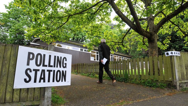 A man arrives at St Mary Magdalene Church Hall in Great Burstead, Essex