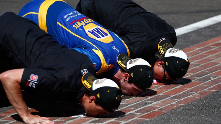 The Indianapolis Motor Speedway is known as &#39;The Brickyard&#39; because of a line of bricks at the start.  Here 2016 winner Alexander Rossi and his team members kiss them
