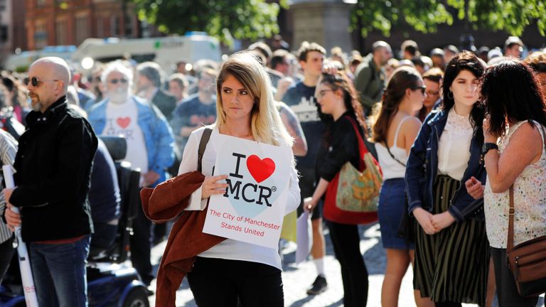 A woman waits to take part in a vigil for the victims of an attack on concert goers at Manchester Arena