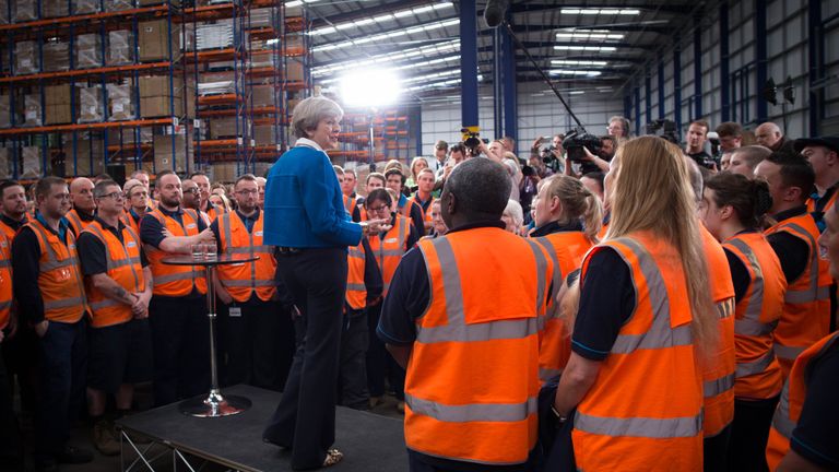 Theresa May fields questions during a visit to a Screwfix factory in Stoke-on-Trent