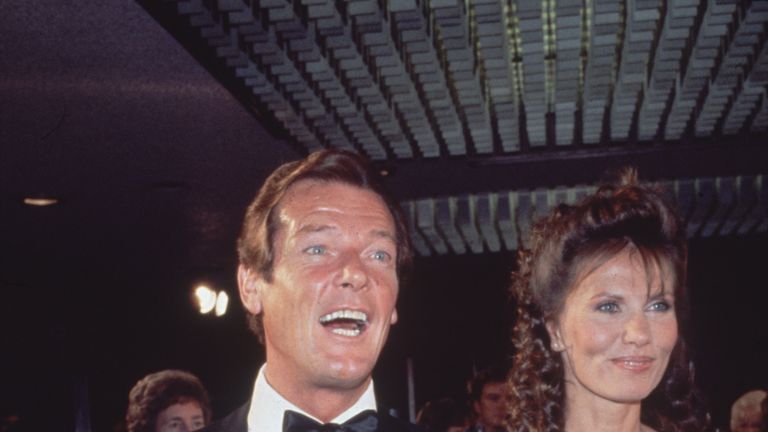1983: The British actor arrives at the premiere of 'Octopussy' with co-star Maud Adams