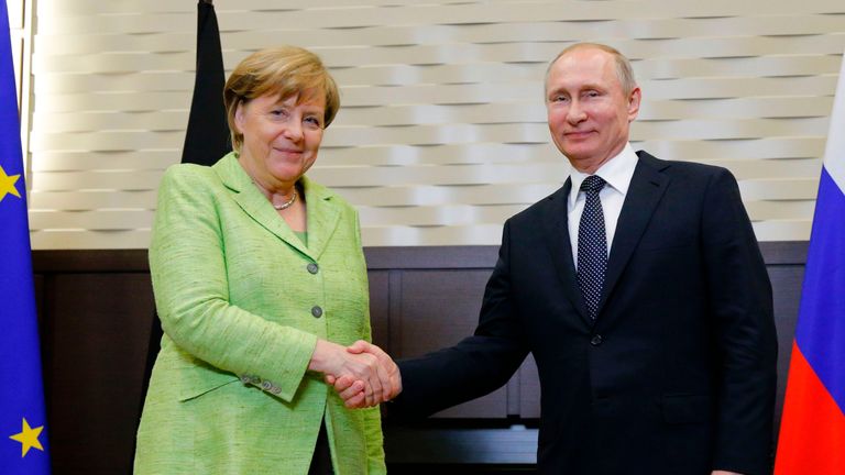 Russian President Vladimir Putin shakes hands with German Chancellor Angela Merkel during their talks in Sochi