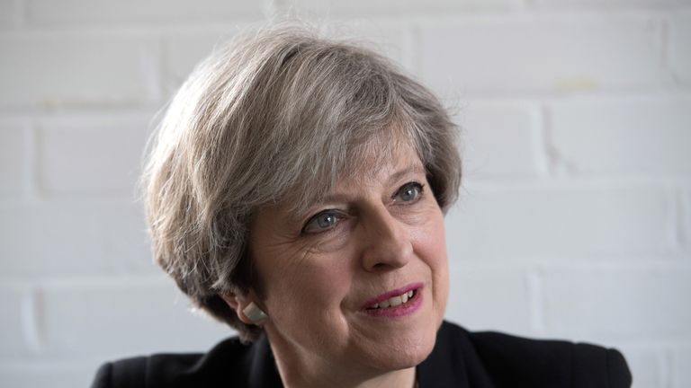 Theresa May chats with activists during a visit to the Young Minds charity