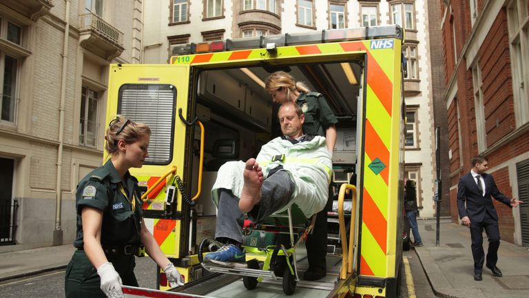 Giles Wooltorton is loaded into an ambulance after Jeremy Corbyn's car ran over his foot
