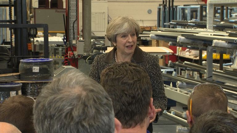 Theresa May talks to factory workers in Leeds.