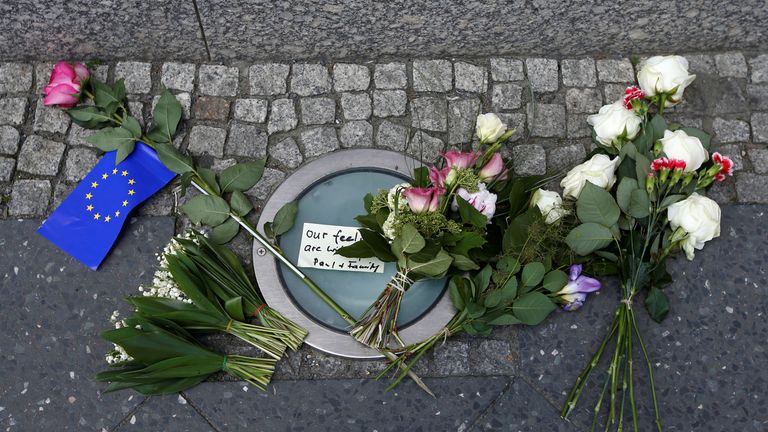 The flowers were left with an EU flag outside the embassy