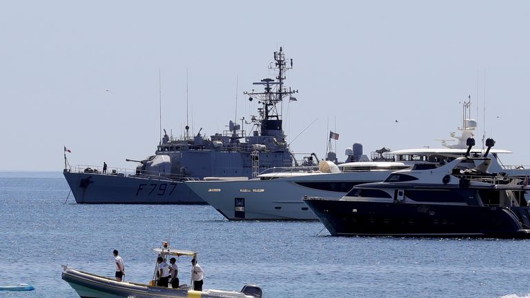 A French navy warship anchors amongst super yachts ahead of the festival