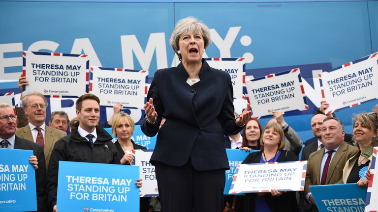 Theresa May addresses supporters in front of the Conservative party&#39;s campaign bus