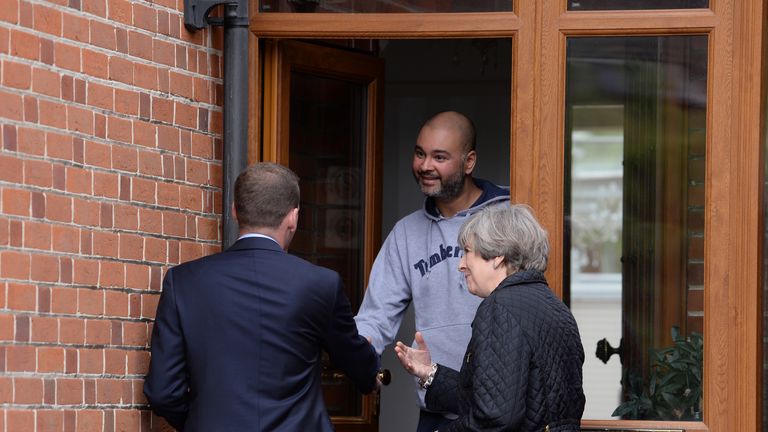Theresa May meets a resident with Conservative candidate Paul Holmes