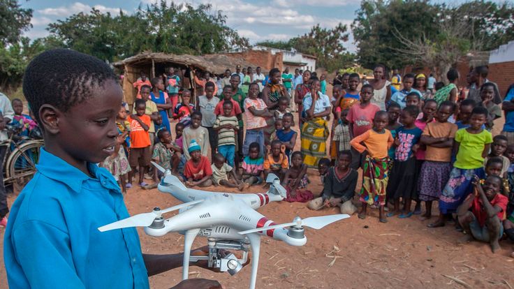 A child holds a drone during a drone awareness and safety demonstration on June 22, 2017, in regards to humanitarian drone corridor testing under the UNICEF-funded Humanitarian Drone Corridor testing project, in the hard-to-reach rural Chanthunthu Village Health Clinic in Kasungu
