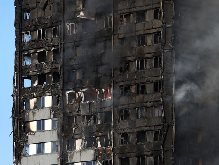 The burnt facade of a tower block is seen as firefighters tackle a serious fire at Latimer Road in West London