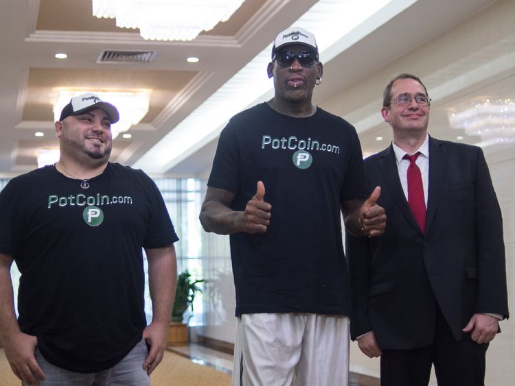 Flamboyant former NBA star Dennis Rodman (C) of the US poses with members of his party following his arrival at Pyongyang International Airport