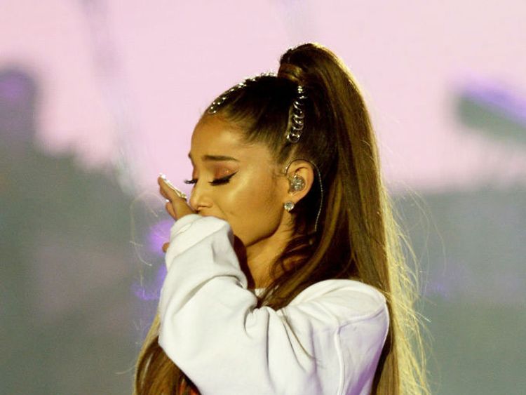 Ariana Grande performs on stage