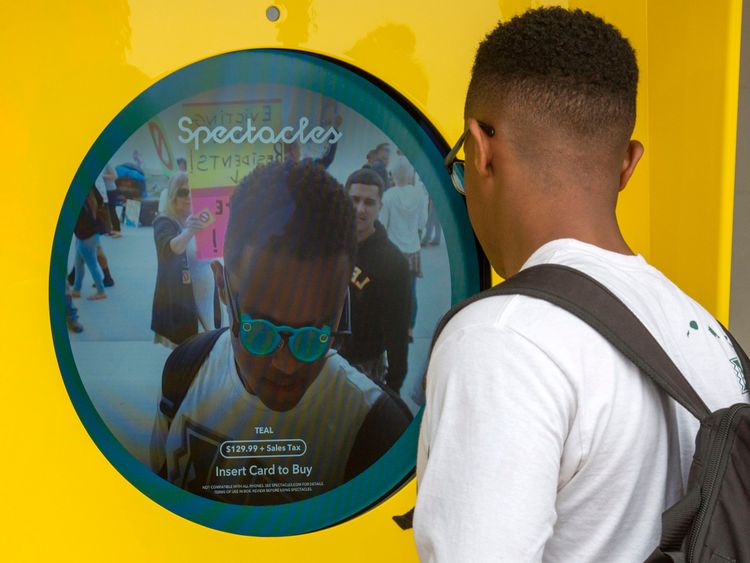 A Snapchat fan looks at a Spectacles vending machine in Venice, Los Angeles