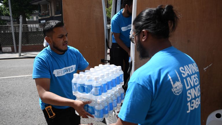 Charity workers deliver water for Grenfell Tower residents