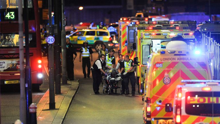 Police officers and members of the emergency services attend to a person injured in an apparent terror attack on London Bridge in central London on June 3, 2017