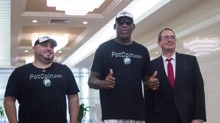 Flamboyant former NBA star Dennis Rodman (C) of the US poses with members of his party following his arrival at Pyongyang International Airport