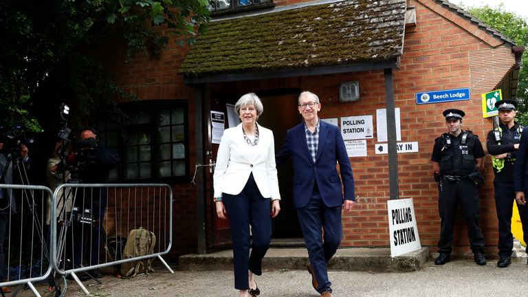  Theresa May and her husband Philip leave a polling station in Sonning