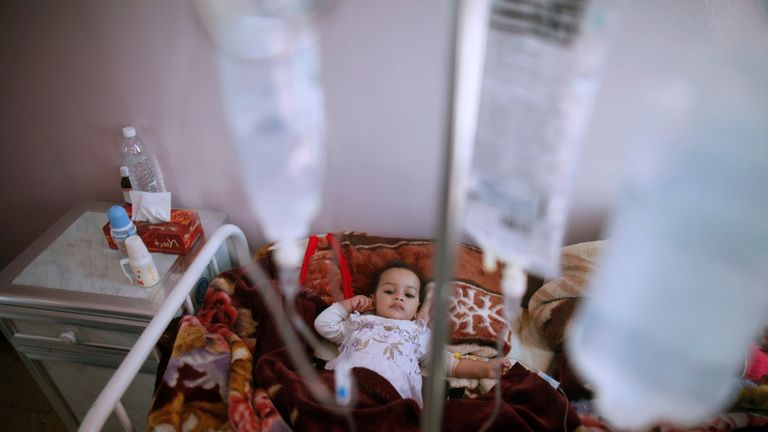 A girl with cholera receives treatment through a drip in a centre in Sanaa, Yemen