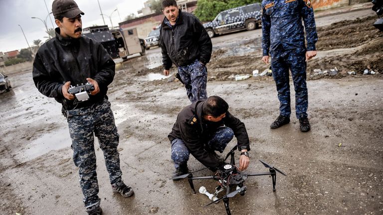 Members of the Iraqi forces prepare to fly a drone armed with grenades in the fight against Islamic State (IS) group jihadists in the northern Iraqi city of Mosul on March 14, 2017