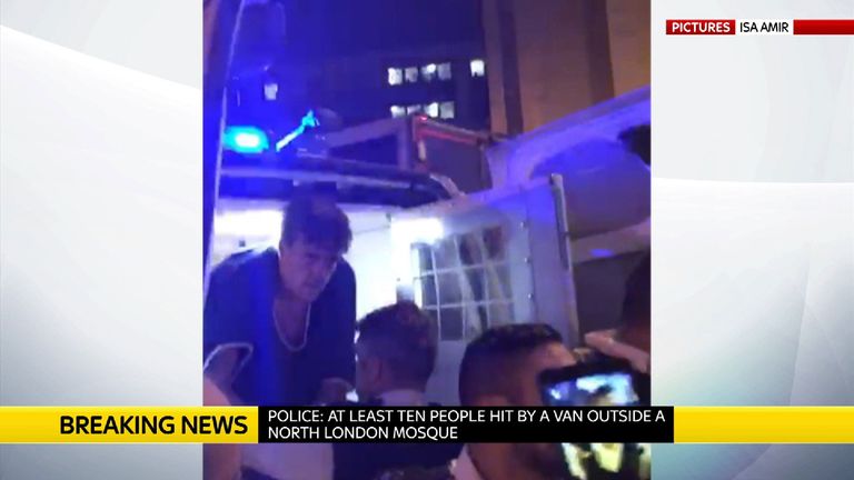 A man is arrested and put in the back of a police van after the collision in north London. Pic: Isa Amir
