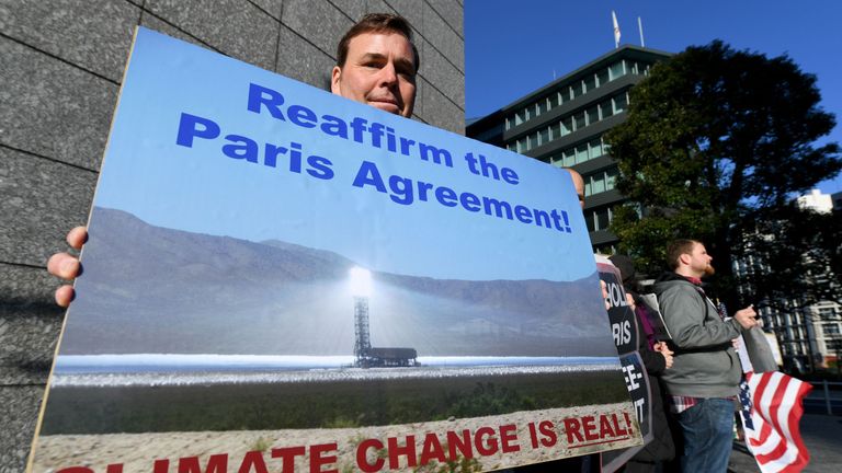 US residents living in Japan and local residents hold a rally near the US embassy in Tokyo on March 16, 2017. About 13 demonstrators demanded visiting US Secretary of State Rex Tillerson to reaffirm the US commitment to the Paris Agreement on climate change