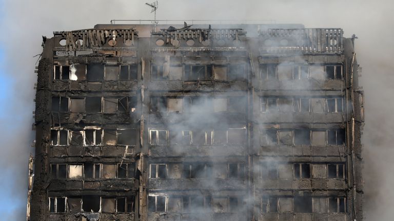 Smoke billows from a tower block severely damaged by a serious fire, in north Kensington, West London