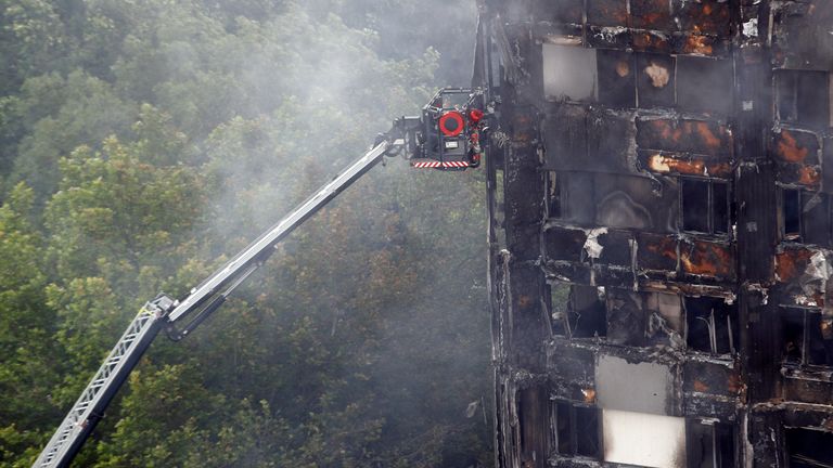 Smoke continues to drift from the tower block 
