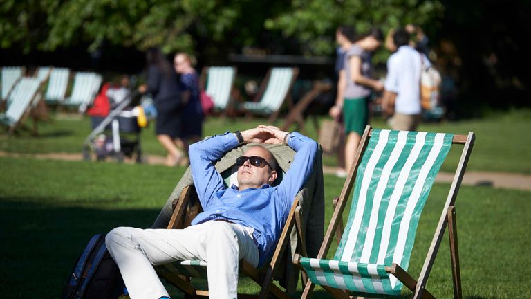 People enjoy the afternoon sunshine in Green Park in central London in May