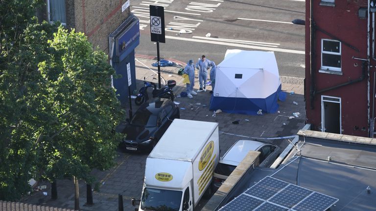 Forensic teams examine the scene where a van ploughed into pedestrians in Finsbury Park