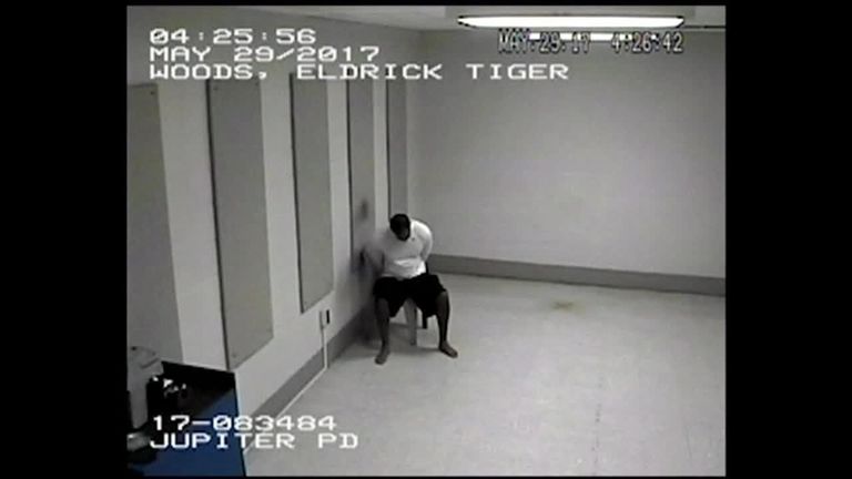 Tiger Woods slumps in his chair after arrest.