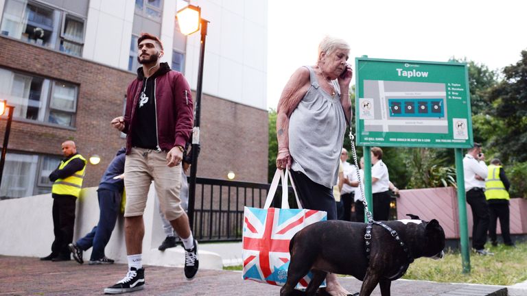 Resident Shirley Phillips leaves the Taplow tower block on the Chalcots Estate in Camden, London
