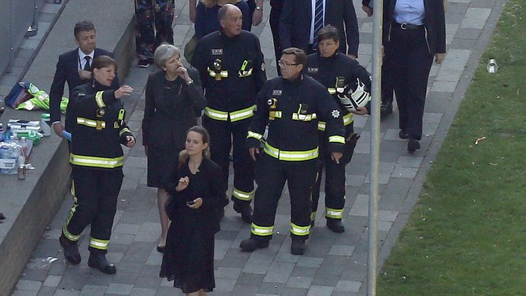 Prime Minister Theresa May visits the scene near Grenfell Tower