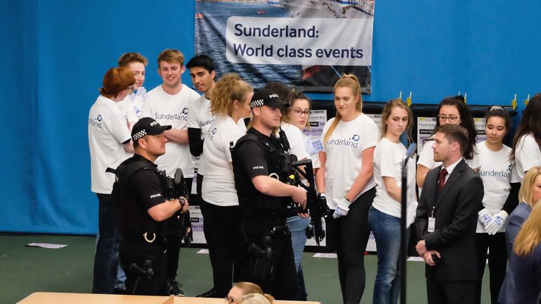 Armed police patrol the floor during the count at the Silksworth Community Pool, Tennis and Wellness Centre as the general election count begins in Sunderland
