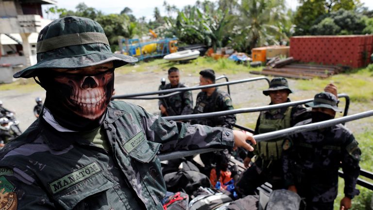 Members of the Philippine National Police Special Action Force ride on a truck in Iligan