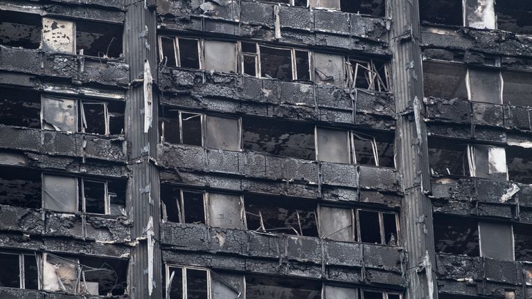 The remains of Grenfell Tower are seen from a neighbouring tower block