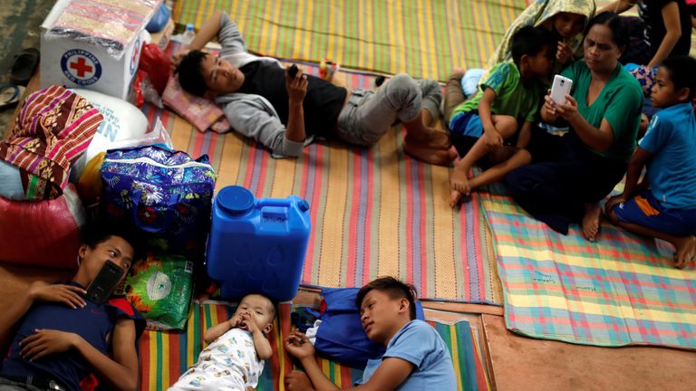 Evacuated residents lie on the floor at an evacuation centre outside Marawi