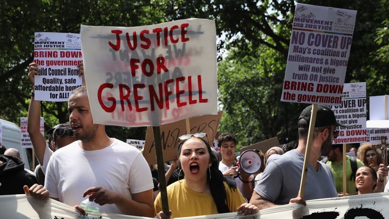  Protesters hold signs calling for 'justice' for the victims of the Grenfell Tower fire